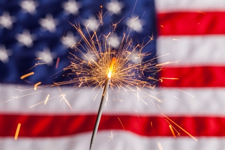 Sparkler in front of U.S. flag